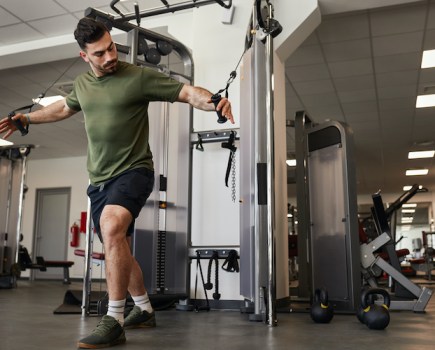 Man working out at an exercise machine in a gym