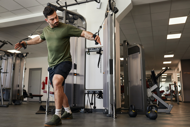 Man working out at an exercise machine in a gym