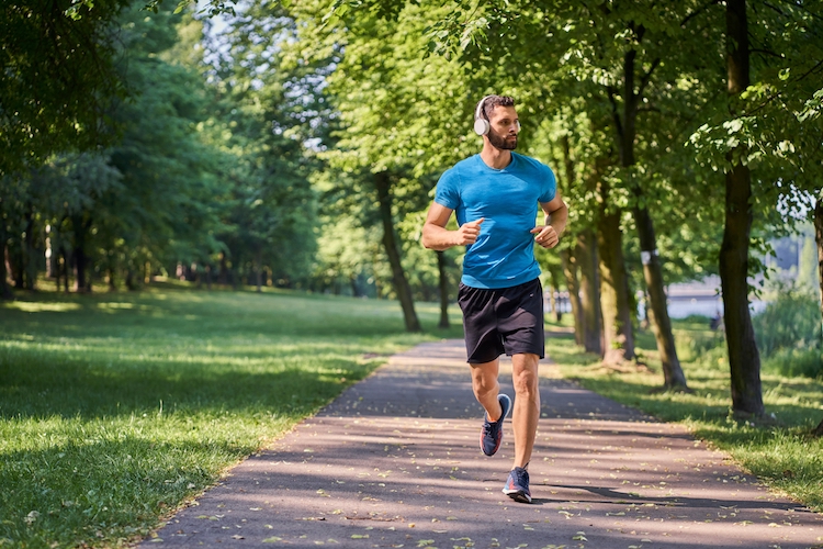 Man with headphones jogging in a park