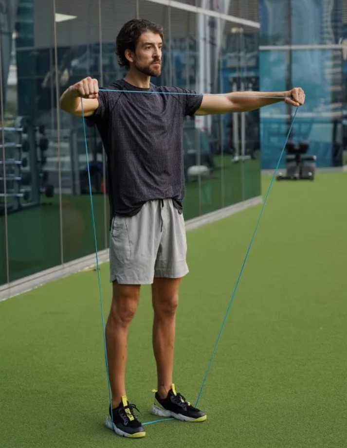 Man performing a band lateral raise