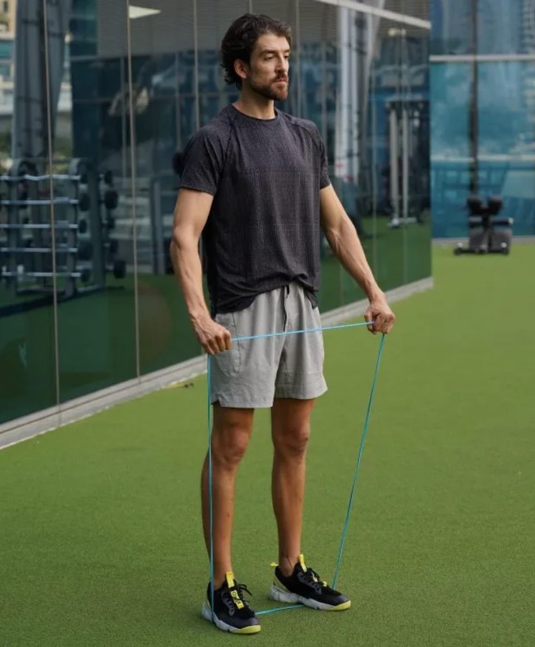 Man performing a band lateral raise