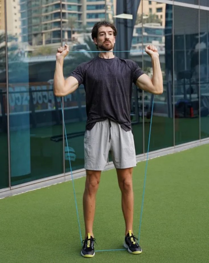 Man performing a banded shoulder press