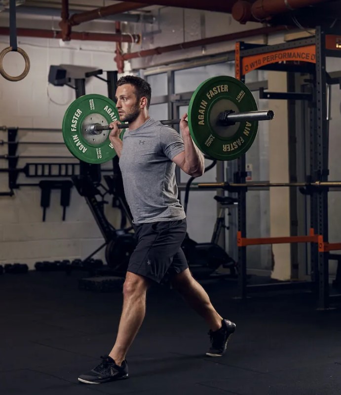 Man performing a barbell split squat