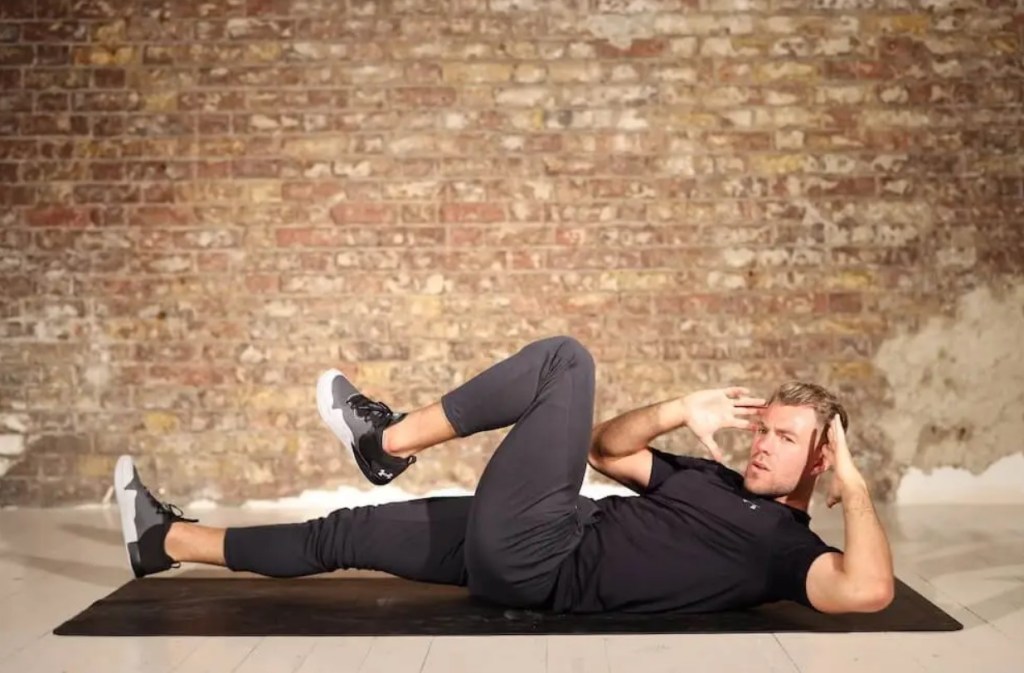 Man performing a bicycle crunch exercise