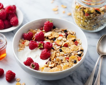 Breakfast cereal and fruit on a table