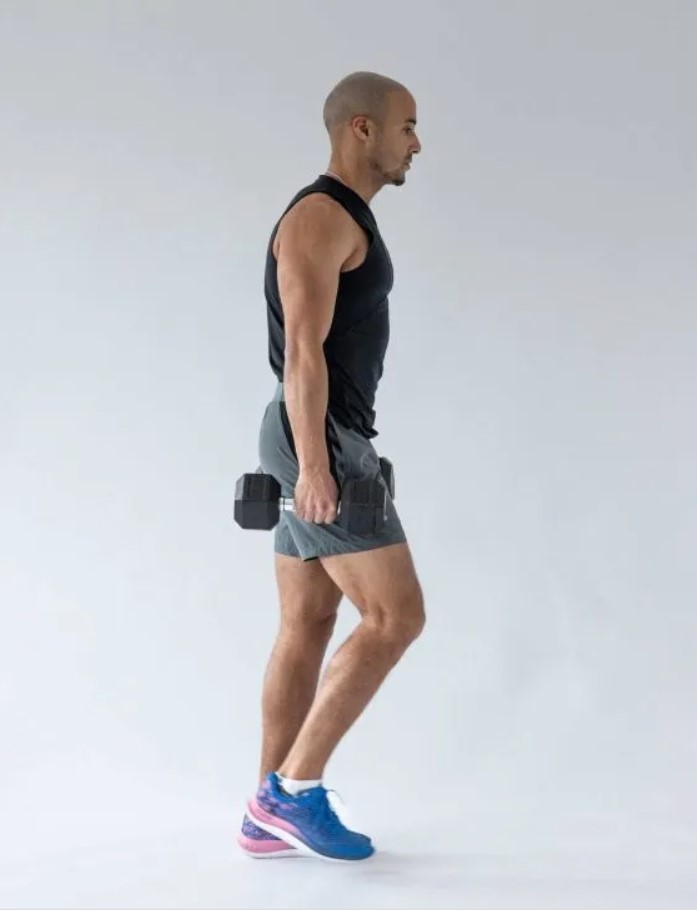 Man performing a dumbbell famer's walk