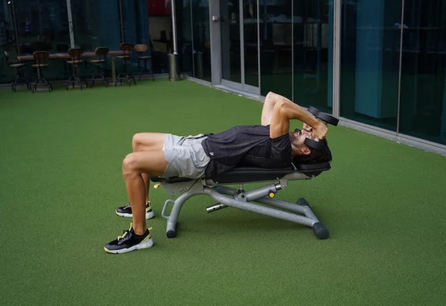 Man performing a dumbbell skullcrusher