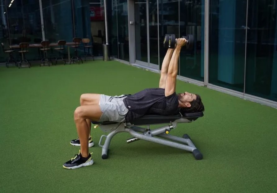 Man performing a dumbbell skullcrusher