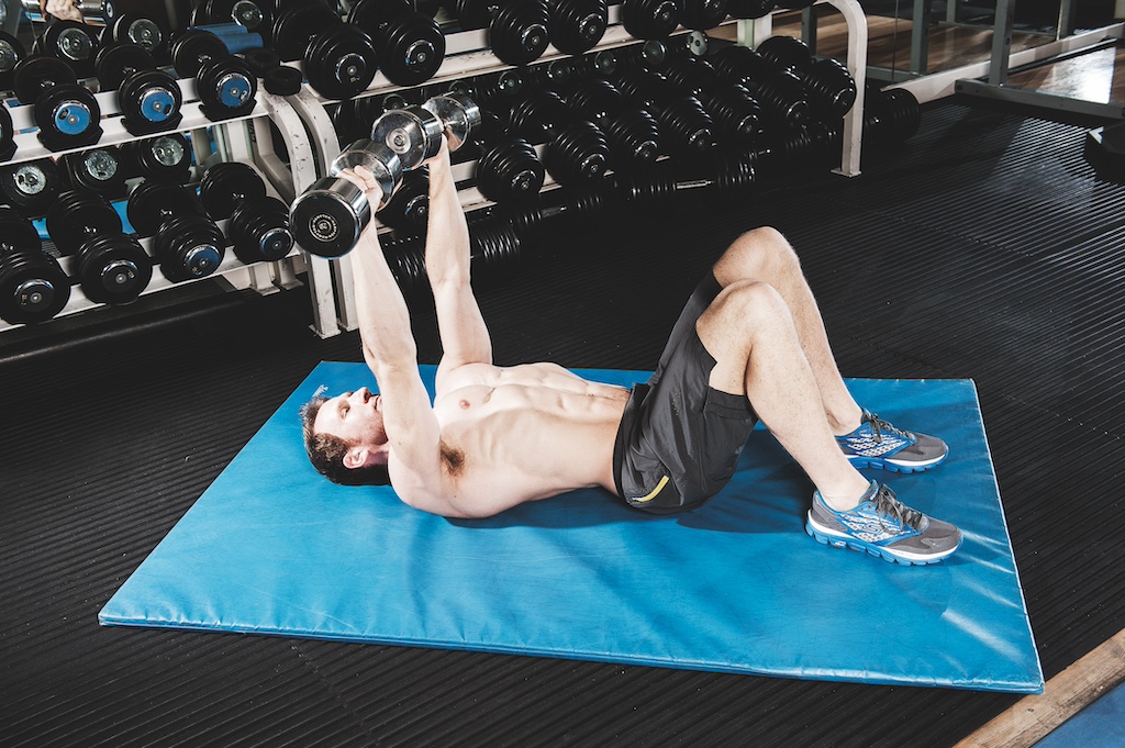 man demonstrating a dumbbell floor press