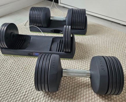 Two JaxJox adjustable dumbbells on the floor