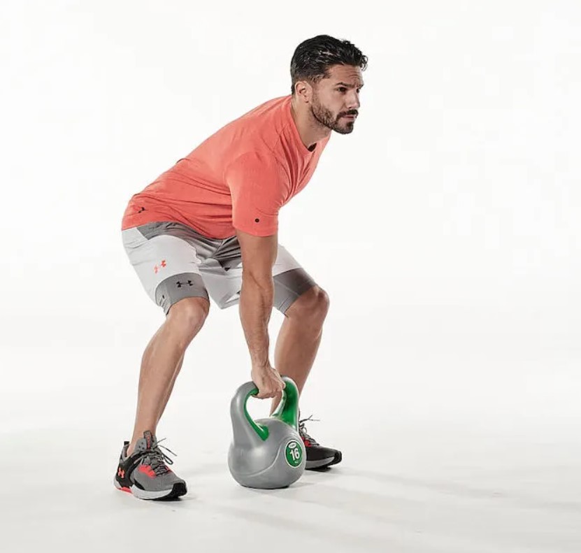 Man performing the kettlebell clean and press