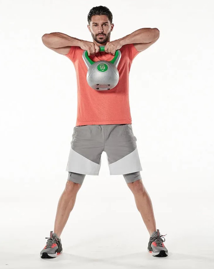 Man performing a kettlebell sumo deadlift