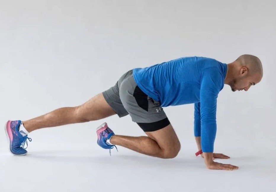 Man performing a pigeon stretch yoga pose