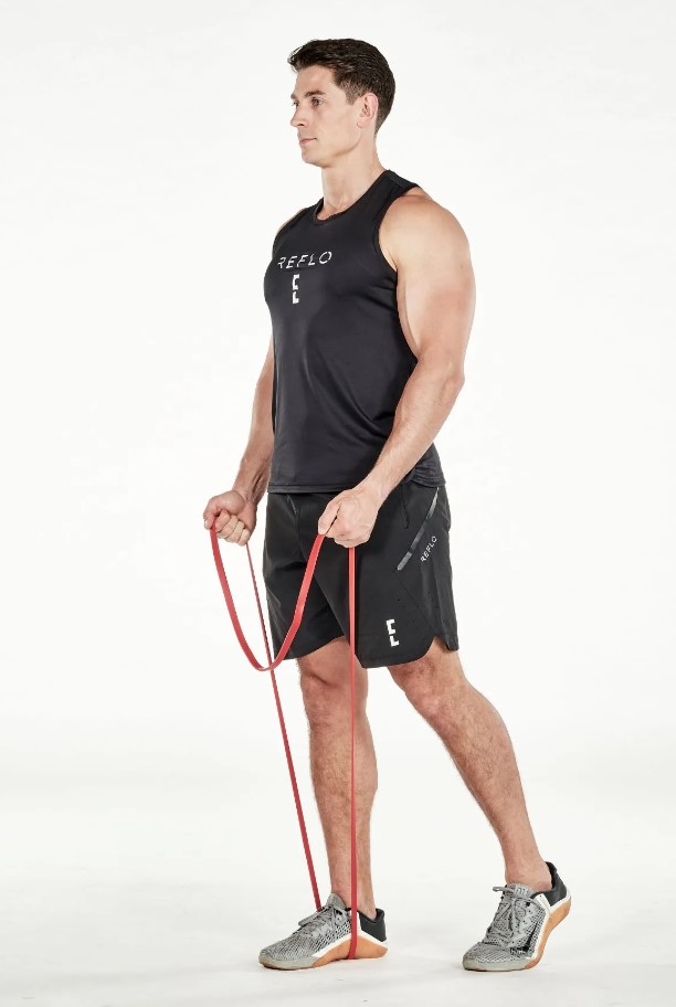 Man performing a resistance band biceps curl