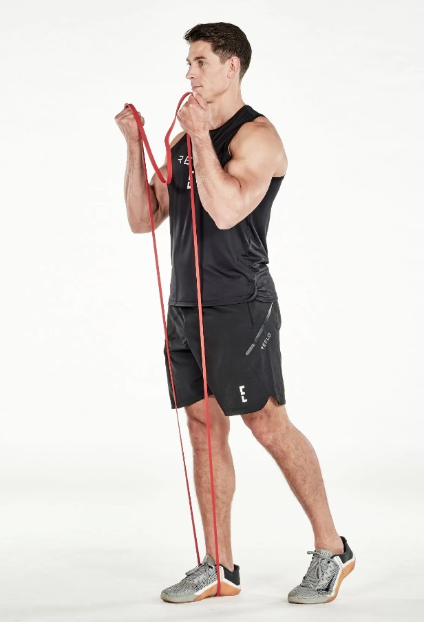 Man performing a resistance band biceps curl