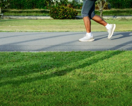 Lower legs of a runner in a park