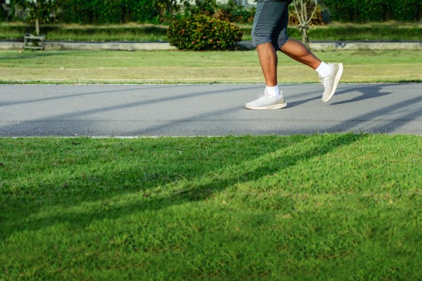 Lower legs of a runner in a park