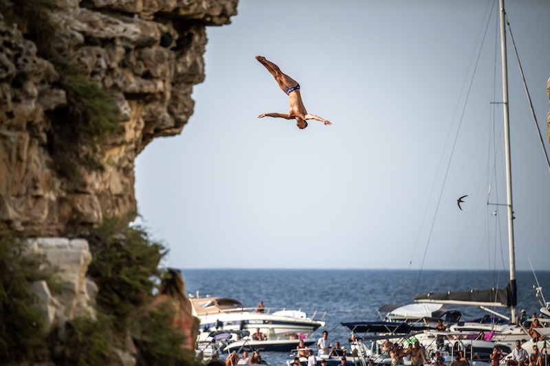 Aidan Heslop dives from the 27.5m platform during the third stop of the 2024 Red Bull Cliff Diving World Series in Polignano a Mare, Italy on 29 June 29, 2024