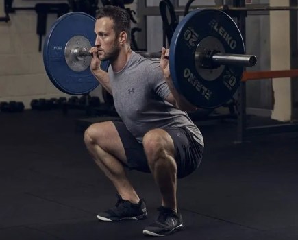 Man performing a barbell squat