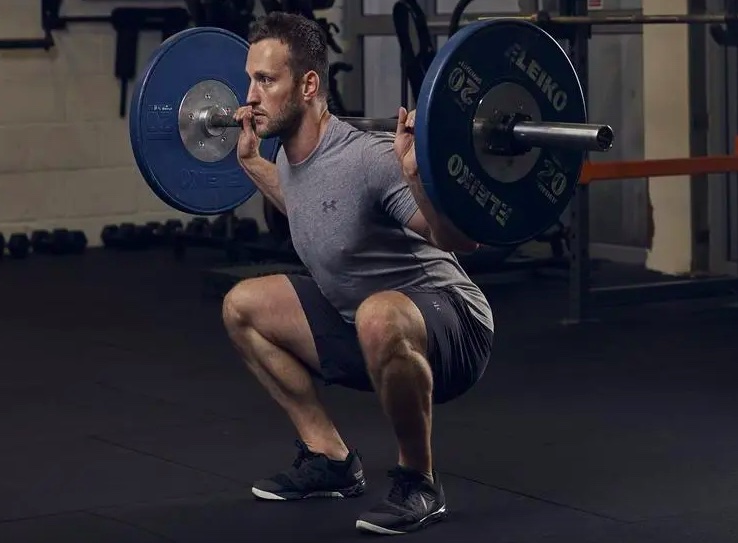 Man performing a barbell squat