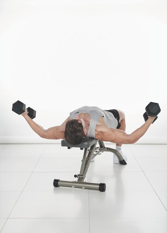 Man performing a dumbbell flye