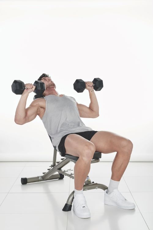 Man performing a Incline dumbbell bench press