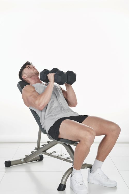 Man performing a dumbbell crush press