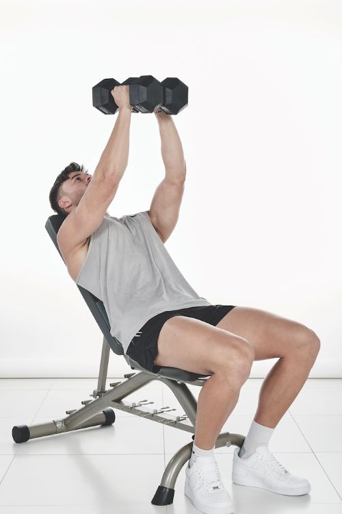 Man performing a dumbbell crush press