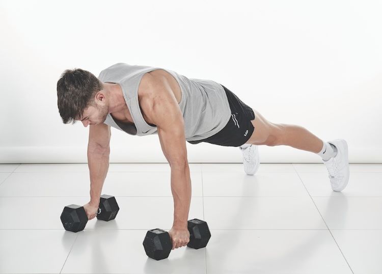 Man performing a dumbbell press-up