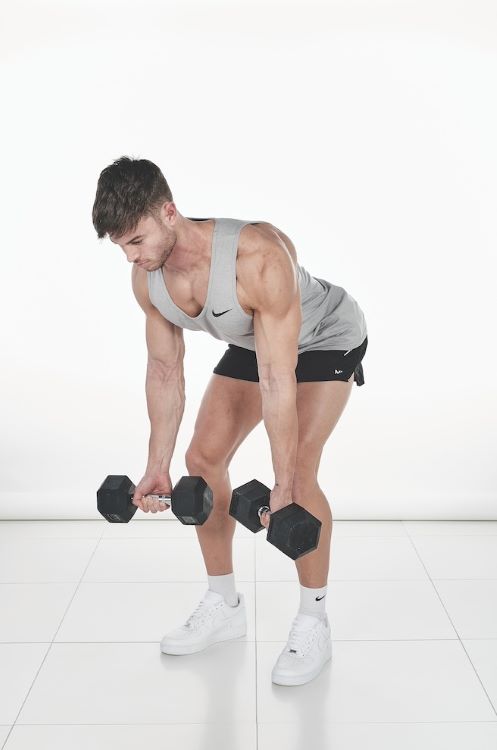 Man performing a bent-over dumbbell reverse row