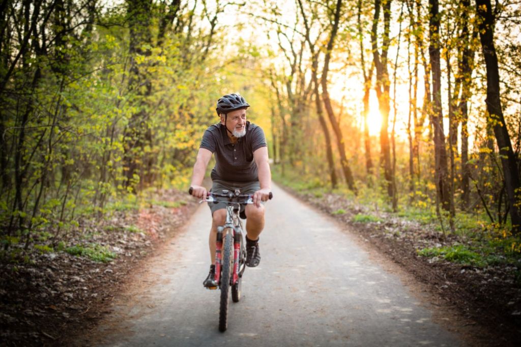 man riding a bike in a forest