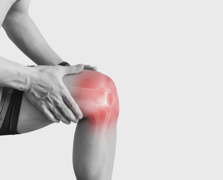 Joint pain, Arthritis and tendon problems. a man touching nee at pain point, on white background
