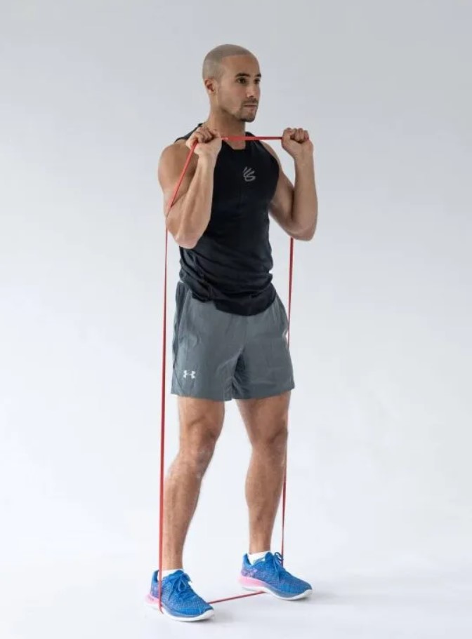 Man performing a banded shoulder press