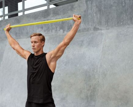 Man pulling a resistance band overhead