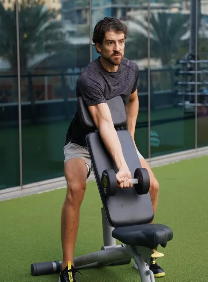 Man performing a db preacher curl