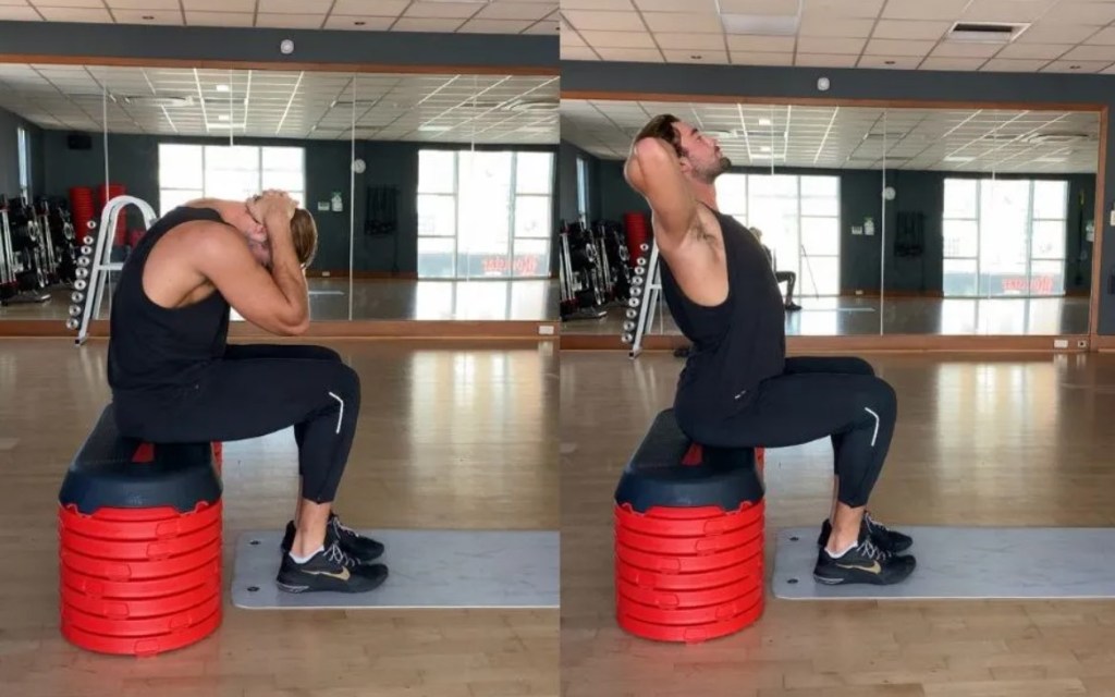 Man performing a desk flye shoulder stretch