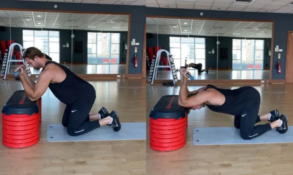 Man performing a dowel bench extension