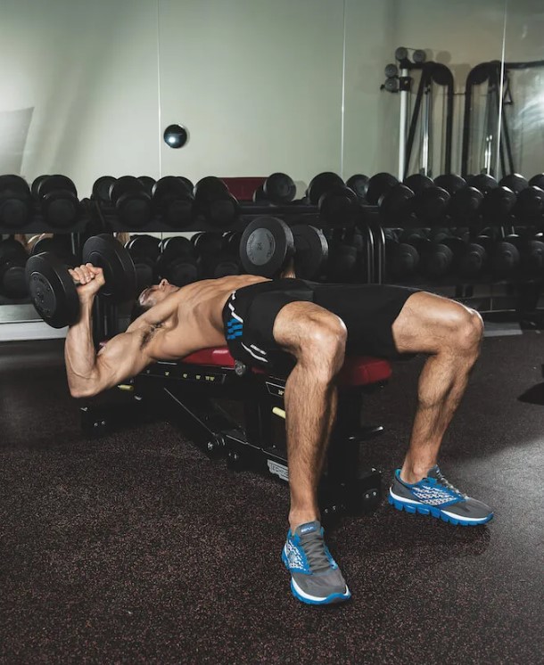 Man performing a dumbbell bench press exercise