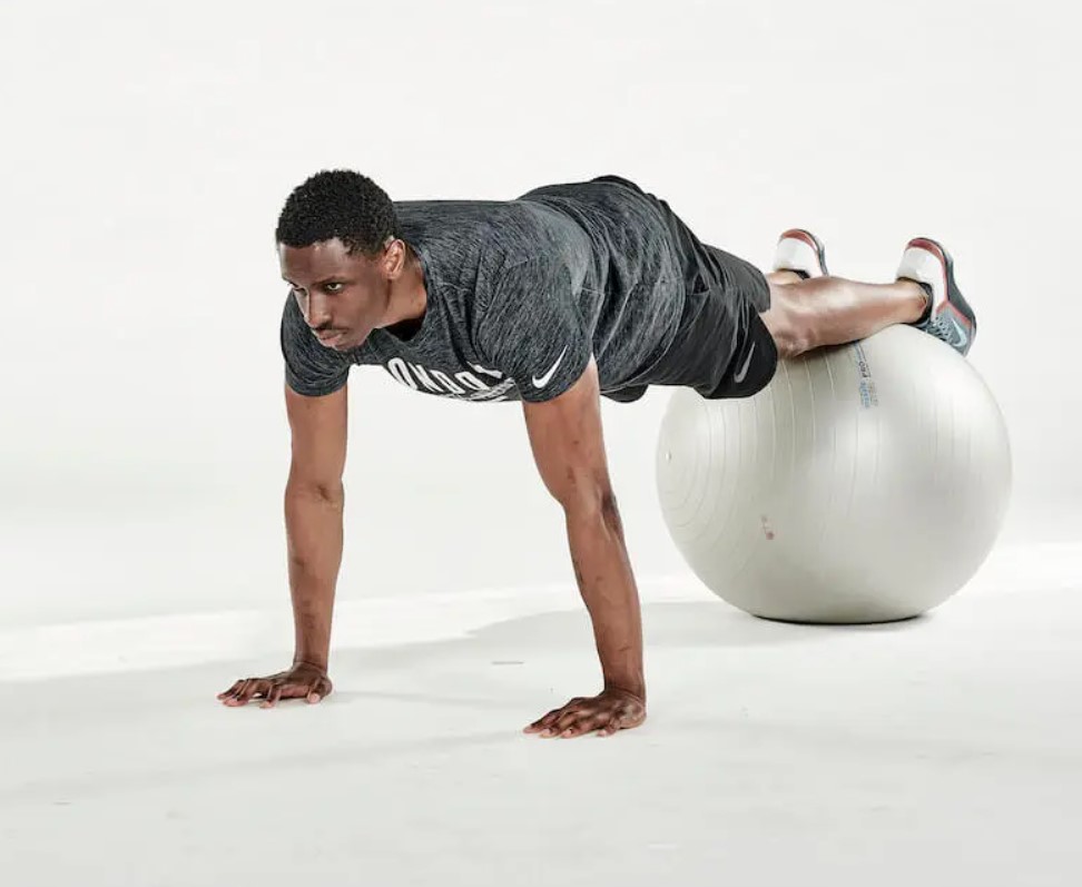 Man performing an exercise ball pike