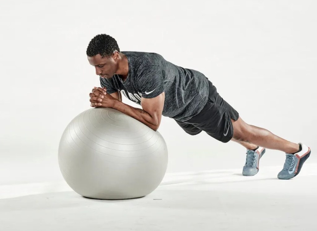 Man performing an exercise ball roll-out