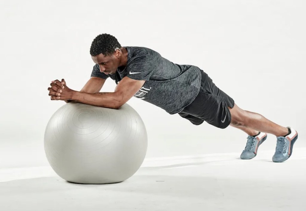 Man performing an exercise ball roll-out