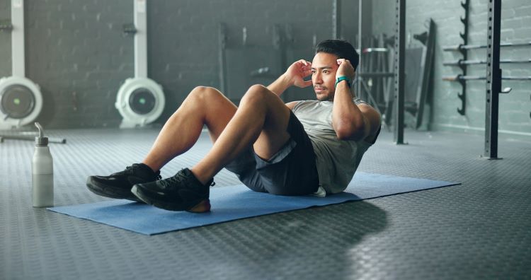 Man doing sit-ups on an exercise mat