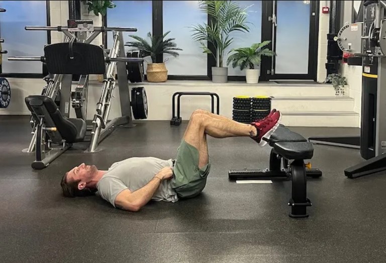 Man performing a 'frogger' floor exercise