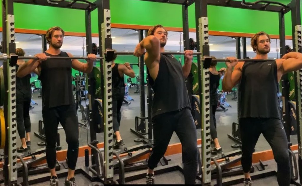 Man performing a front rack barbell stretch