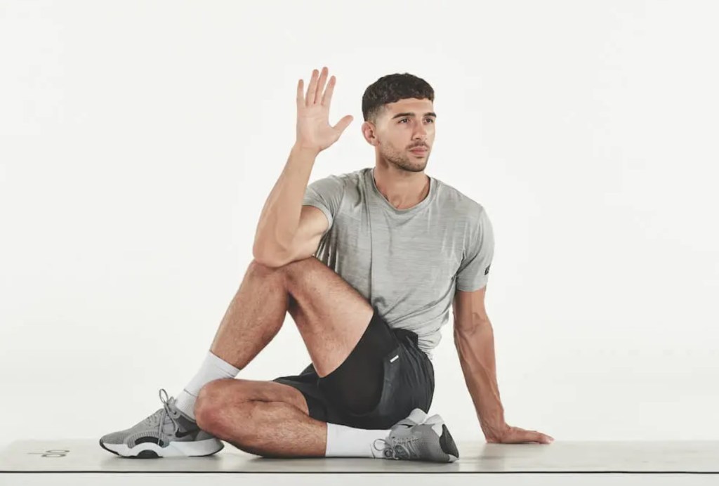 Man performing a half lord of the fishes yoga pose