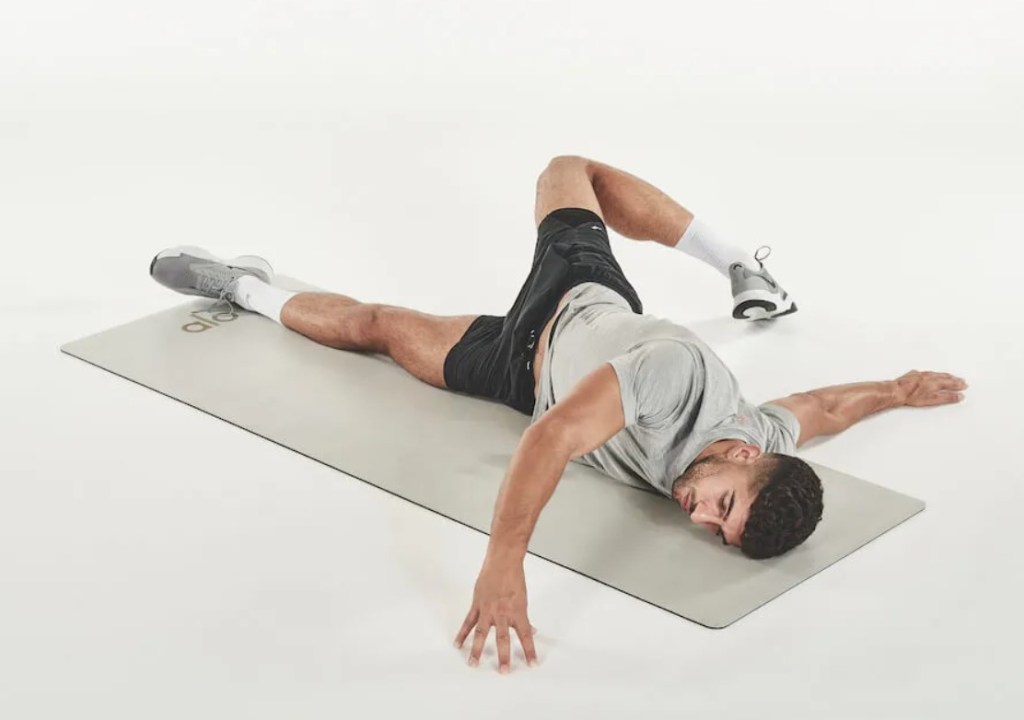 Man performing a prone pec stretch yoga pose