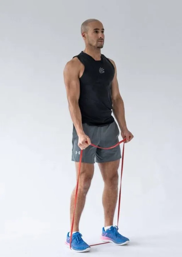 Man performing a resistance band biceps curl