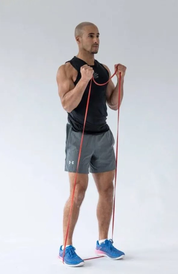 Man performing a resistance band biceps curl