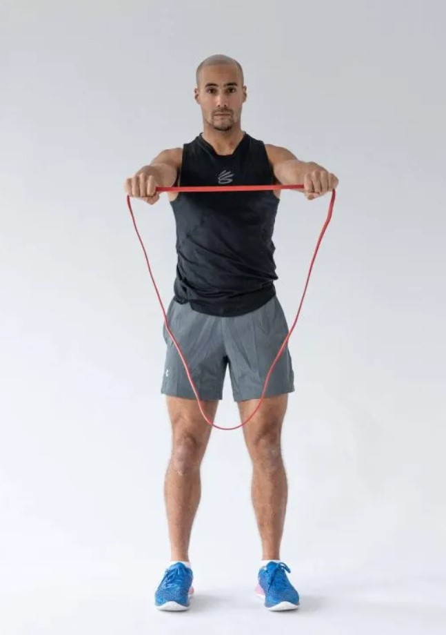 Man performing a resistance band pull-apart