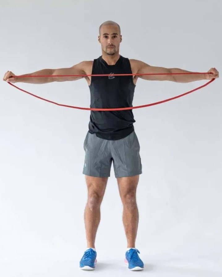 Man performing a resistance band pull-apart